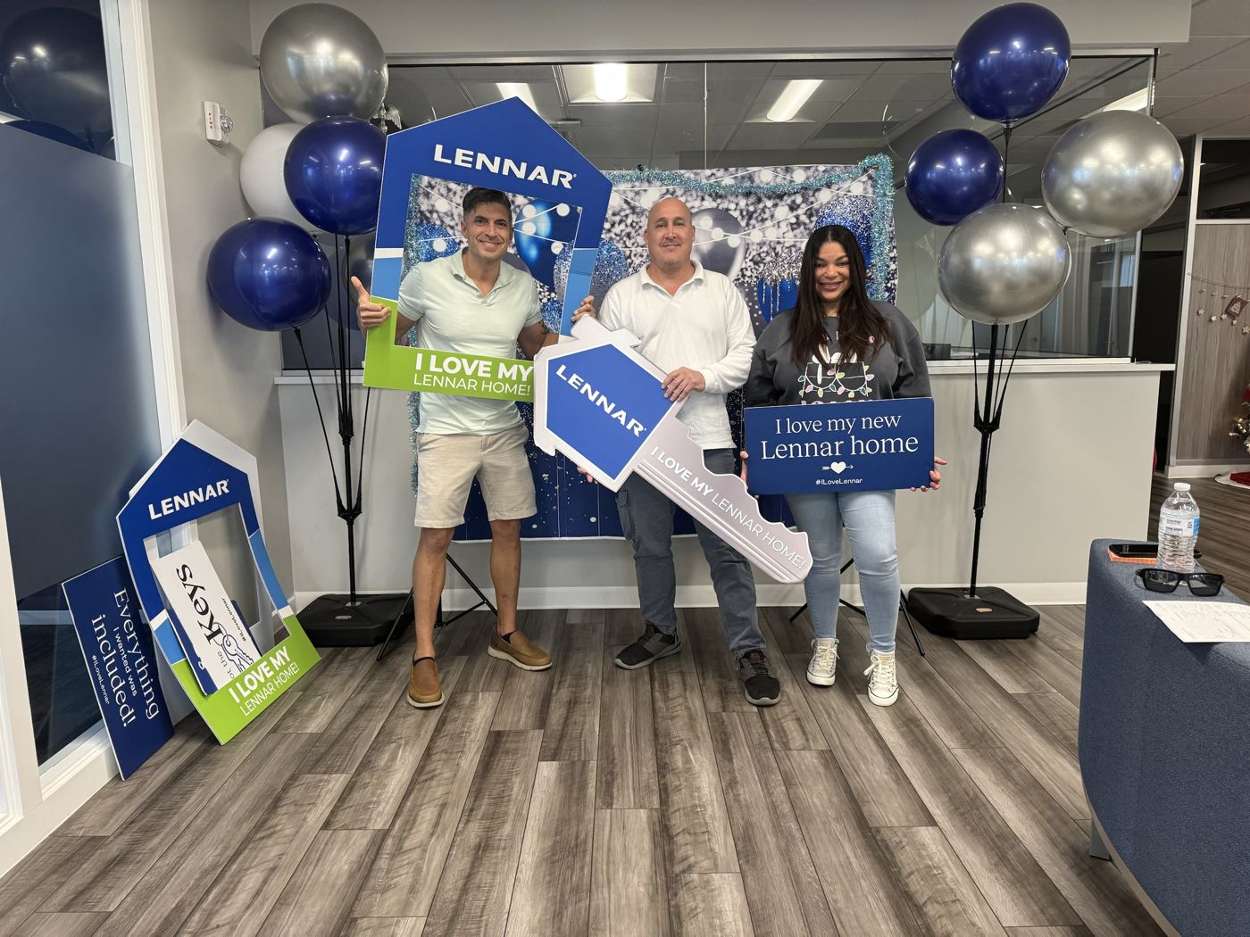 Robert with buyers holding I love my Lennar home signs