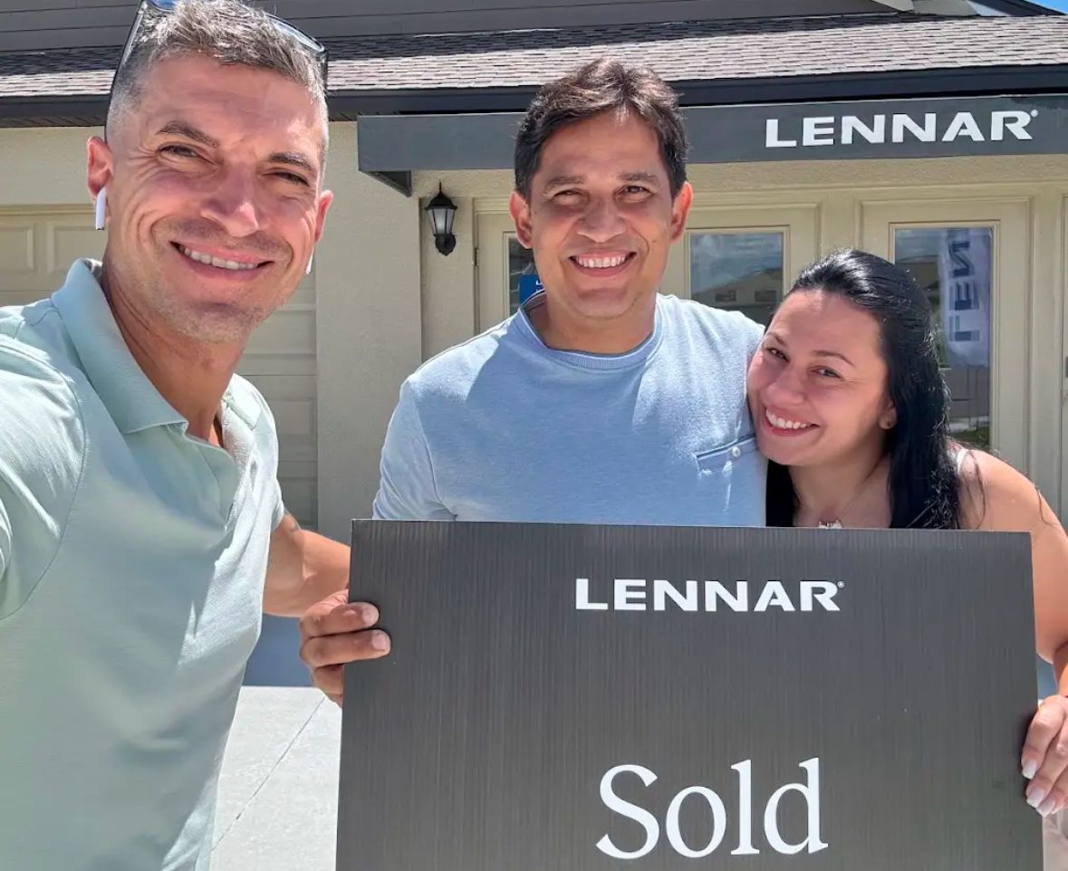 Robert with a couple holding a Lennar SOLD sign