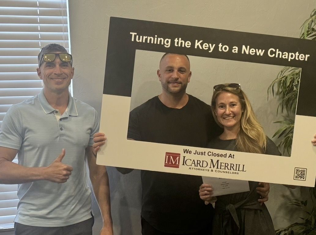 Robert with a couple holding a Turning the Key to a New Chapter frame