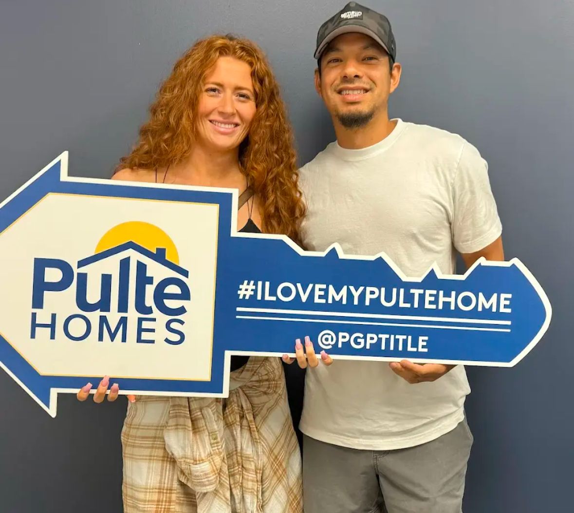 A couple holding their Pulte Homes key